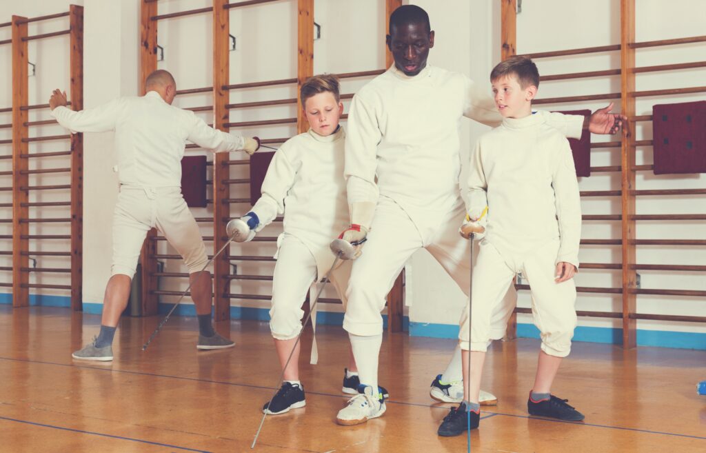 adults-teaching-kids-fencing-scaled