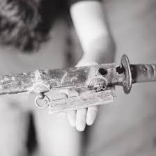 A Katana with a wooden "surrender tag" affixed to it. These tags held the name and addresses of the citizen who surrendered the sword in the hopes that the sword would be returned to them at a later date.